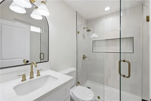 a bathroom with a sink toilet and shower