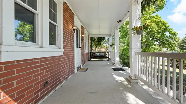a view of a house with backyard and porch