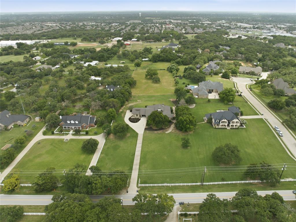 1138 Bancroft Road Keller, TX 76248 - Photo 35 of 39 Expansive property with a large, manicured lawn, mature trees, and a long driveway