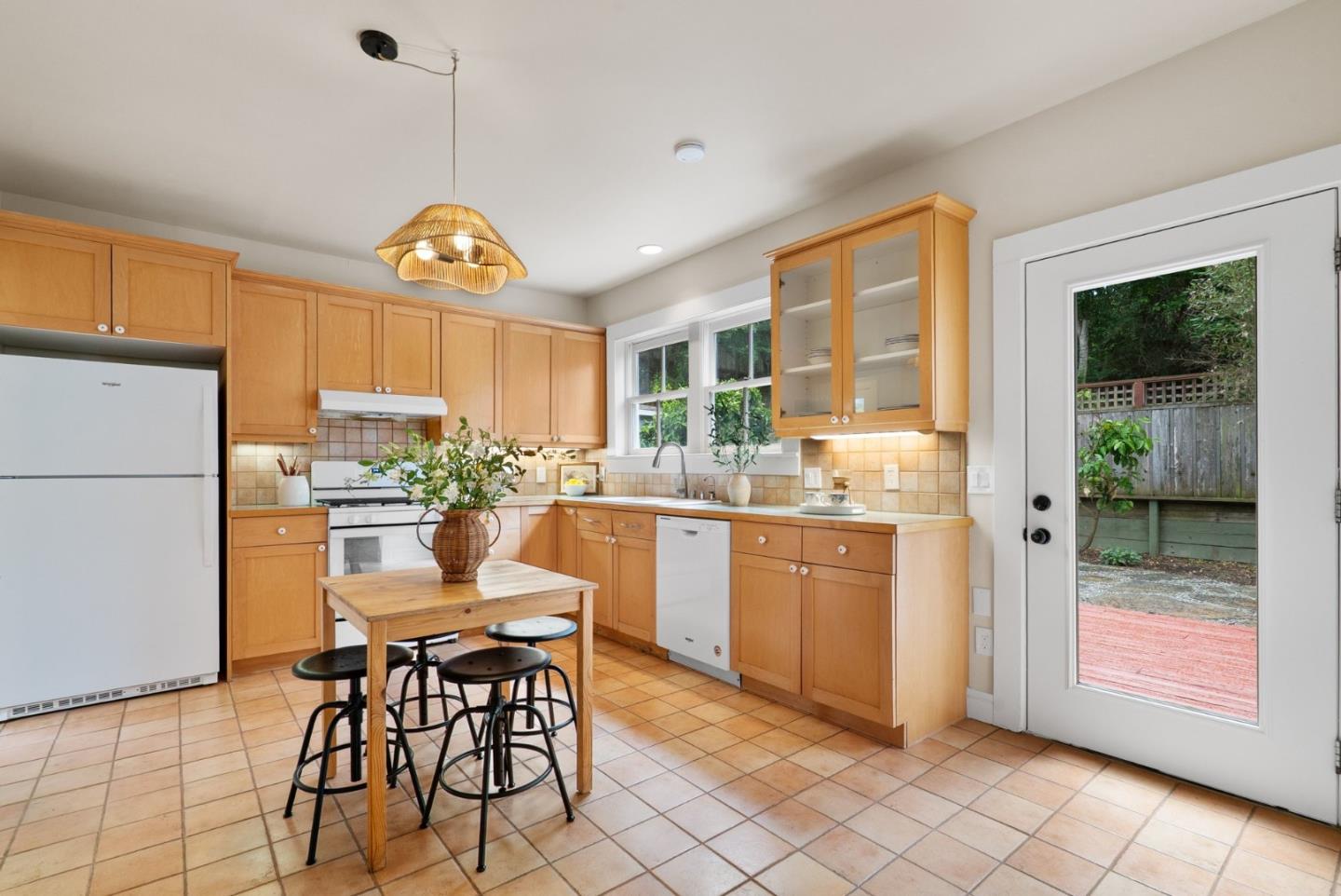 2900 South Main Street Soquel, CA 95073 - Photo 9 of 41 a kitchen with kitchen island granite countertop wooden cabinets a dining table a sink and a large window
