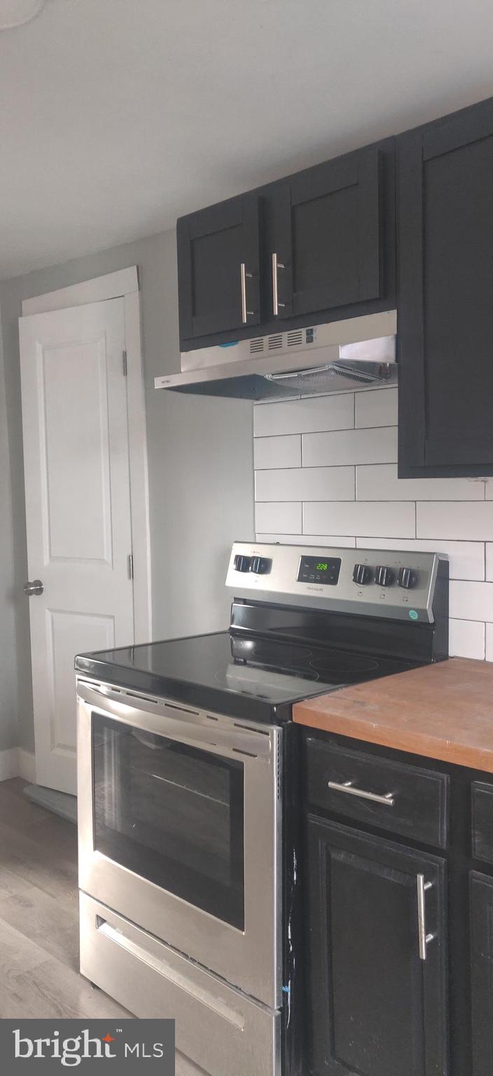 4951 West Thompson Street, Unit 2R Philadelphia, PA 19131 - Photo 3 of 10 a stove top oven sitting inside of a kitchen