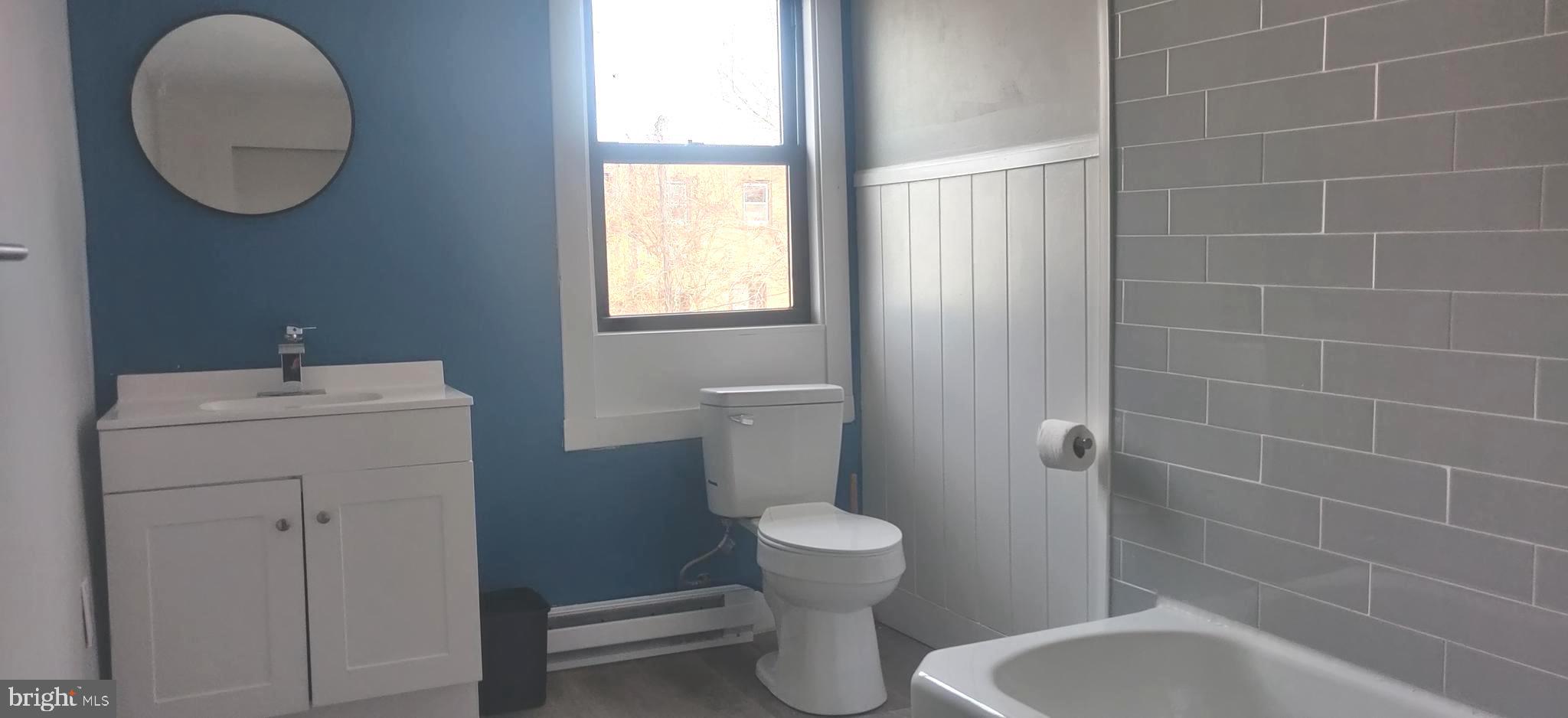 4951 West Thompson Street, Unit 2R Philadelphia, PA 19131 - Photo 4 of 10 a bathroom with a toilet a sink and bathtub