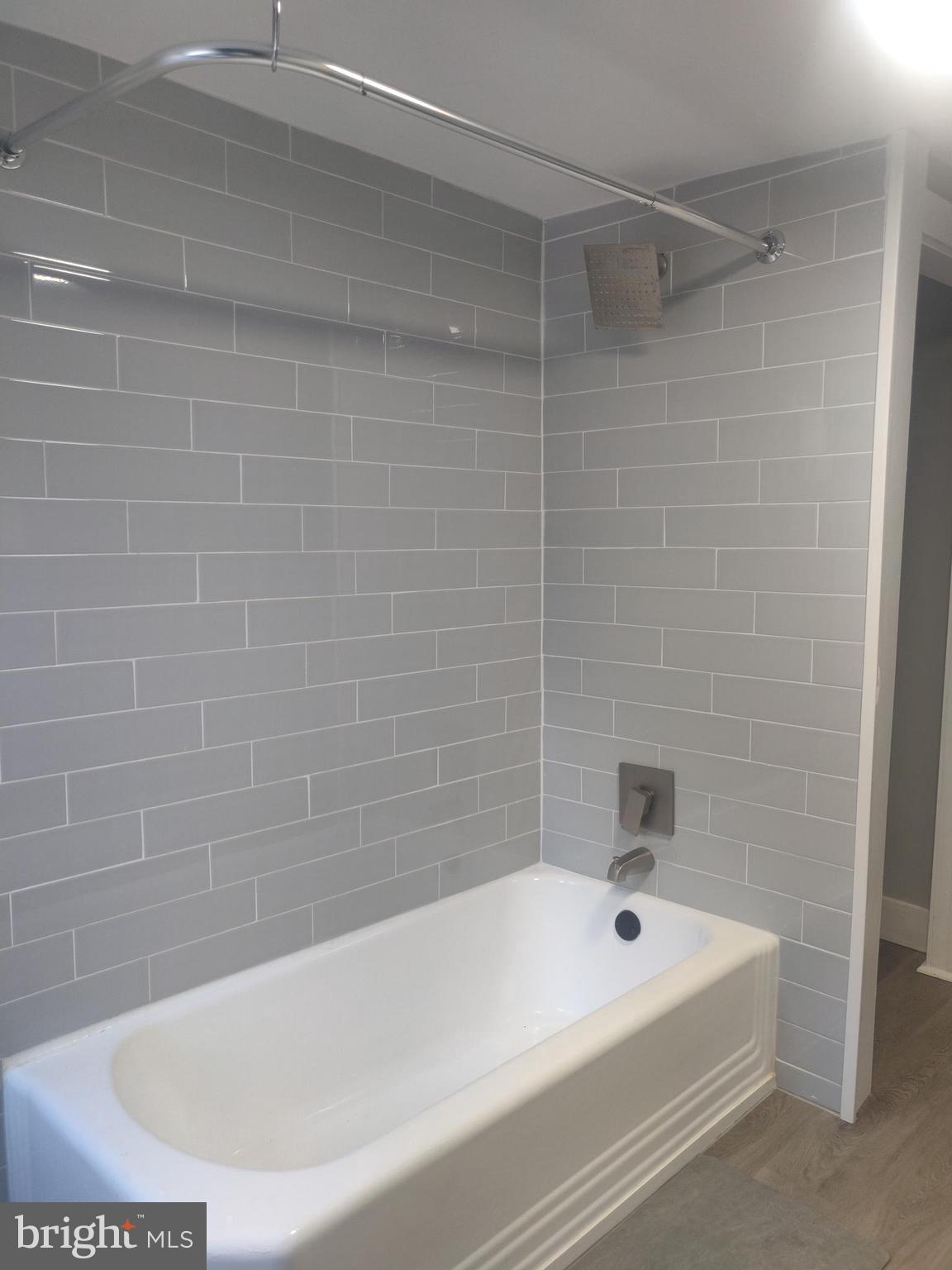 4951 West Thompson Street, Unit 2R Philadelphia, PA 19131 - Photo 7 of 10 a bathroom with a bathtub