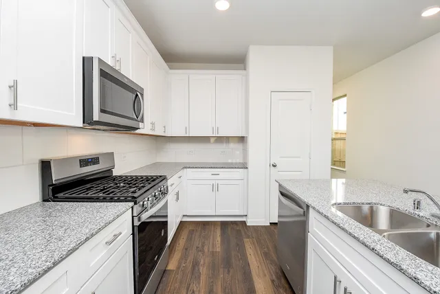 a kitchen with a sink stove and refrigerator