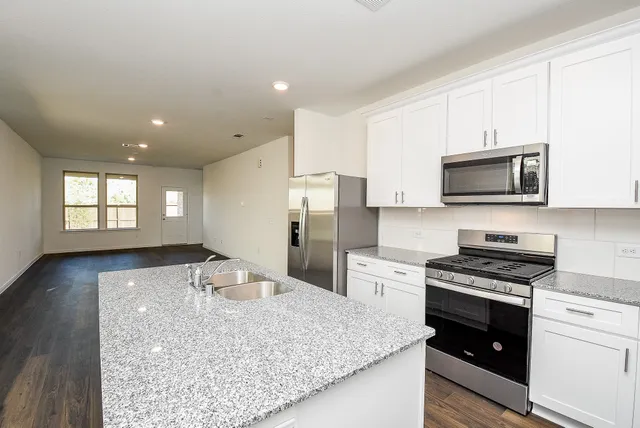 a view of a kitchen counter space window and wooden floor