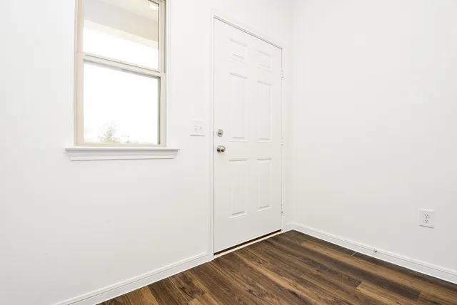 a view of a hallway with wooden floor