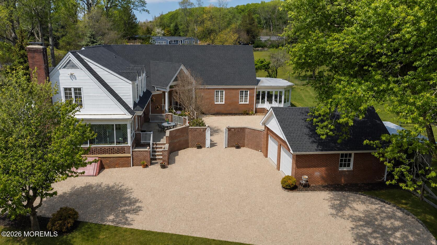 187 Hockhockson Road Colts Neck, NJ 07722 - Photo 3 of 55 a front view of house with yard and trees in the background
