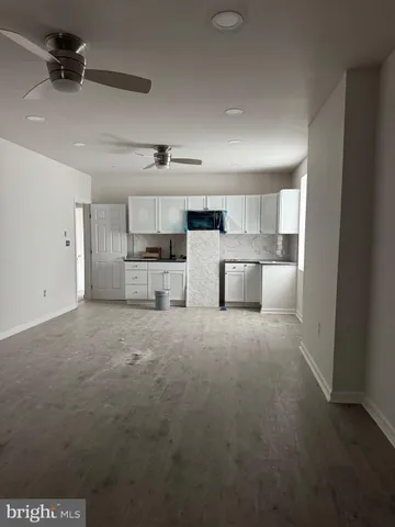 a large kitchen with cabinets and a stove