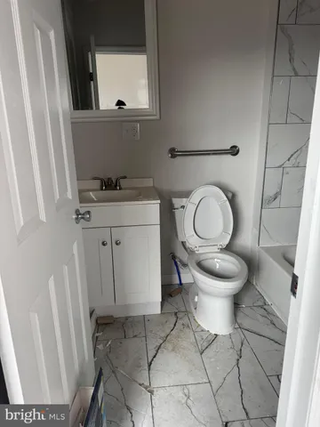 a bathroom with a toilet a sink and a mirror