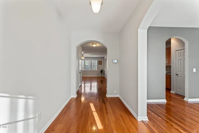a view of a room with wooden floor and a window