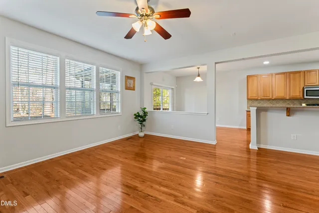a bathroom with a sink a toilet a mirror and shower curtain