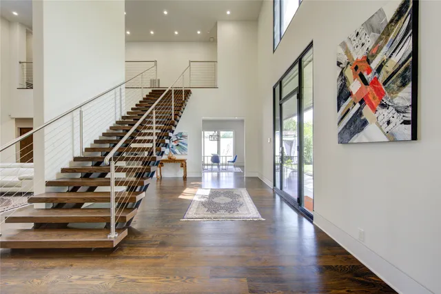 a view of entryway and hall with wooden floor