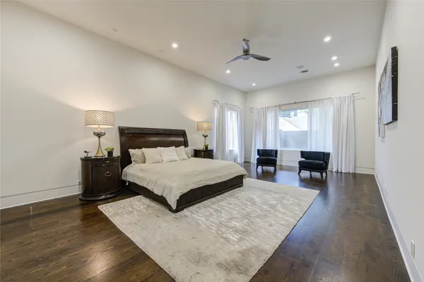 a large bathroom with a granite countertop double vanity sink a mirror and a shower