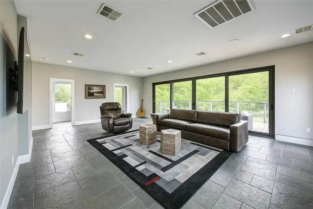 a view of a patio with table and chairs and potted plants