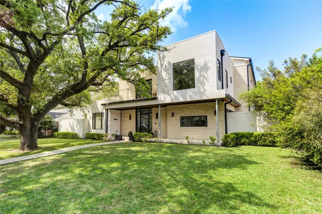 a backyard of a house with table and chairs