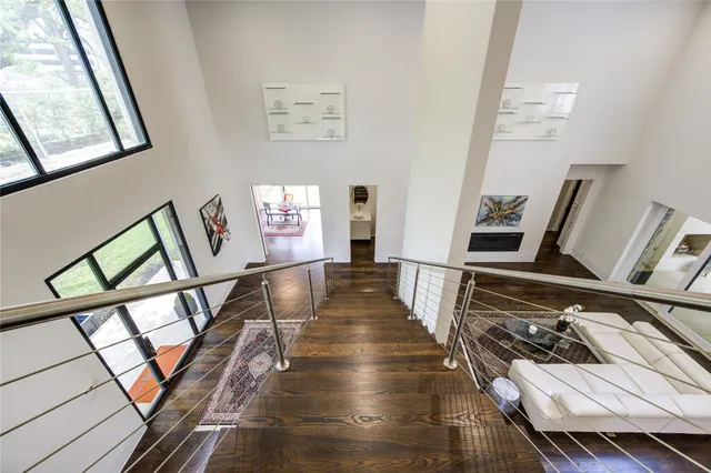 a view of a hallway with wooden furniture and floor to ceiling window
