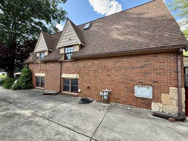 720 South New Street Champaign, IL 61820 - Photo 63 of 73 a view of a brick house with a small yard and large tree
