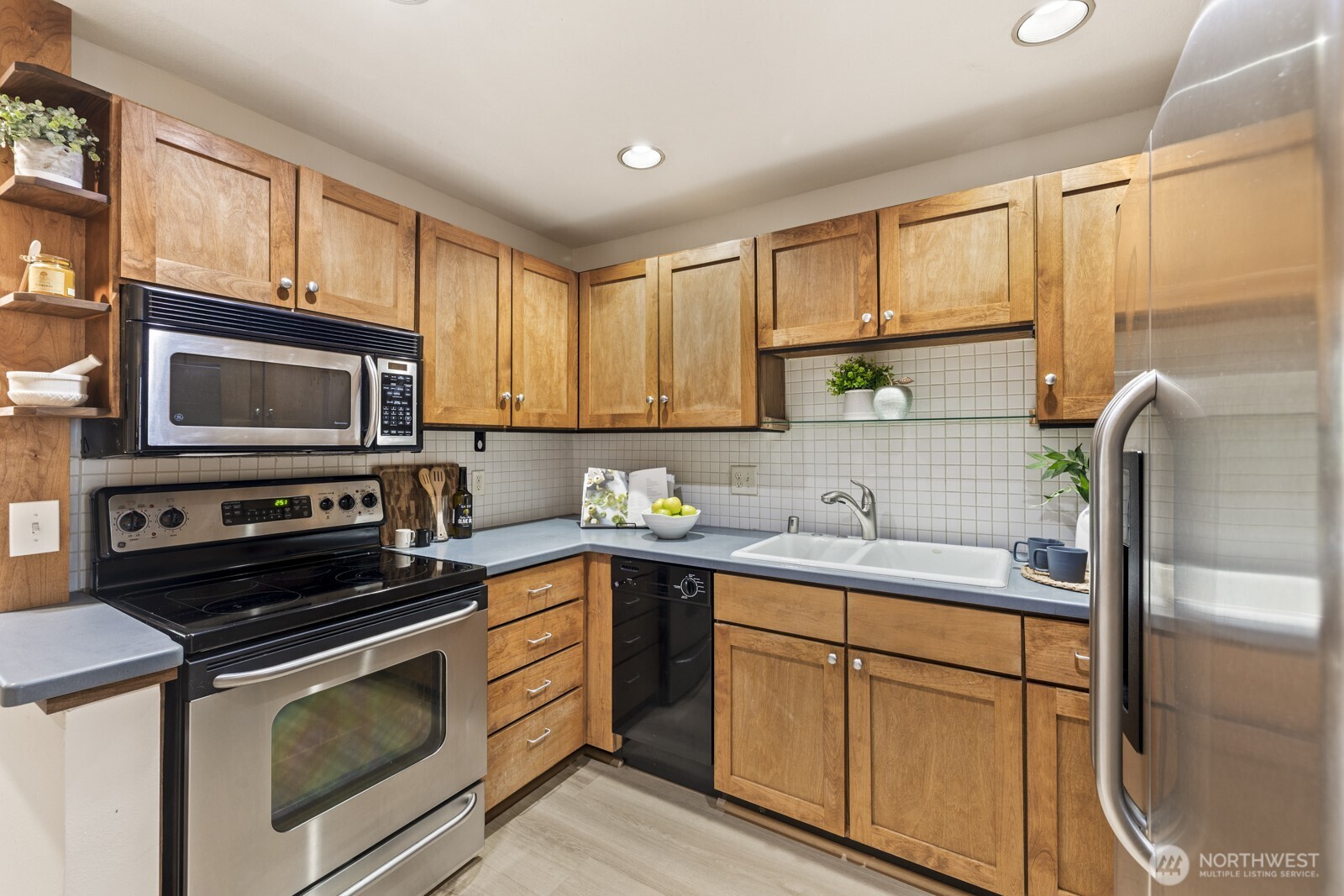 2350 10th Avenue East, Unit 227 Seattle, WA 98102 - Photo 11 of 34 a kitchen with a sink stove and cabinets