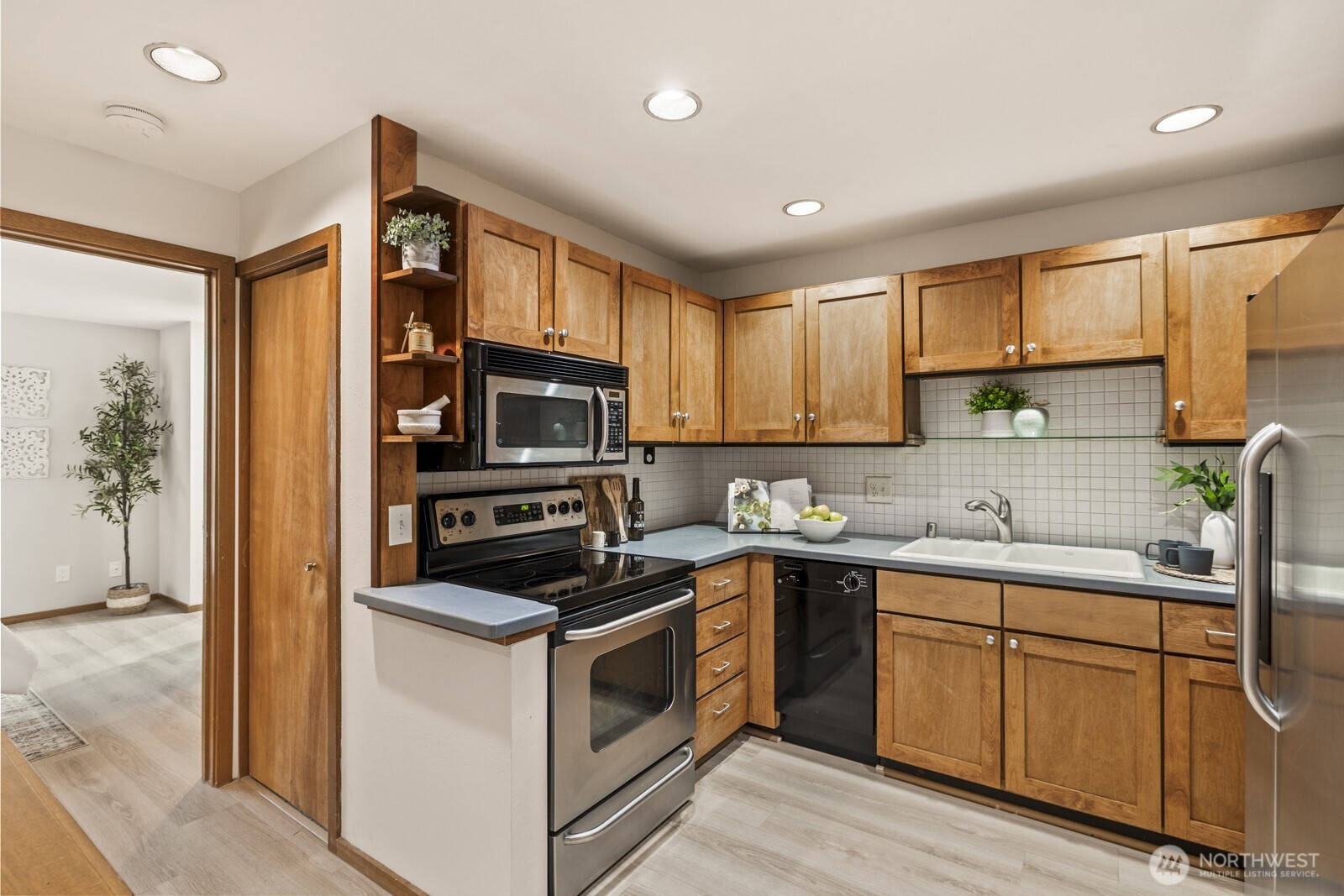 2350 10th Avenue East, Unit 227 Seattle, WA 98102 - Photo 14 of 34 a kitchen with a sink stove and cabinets