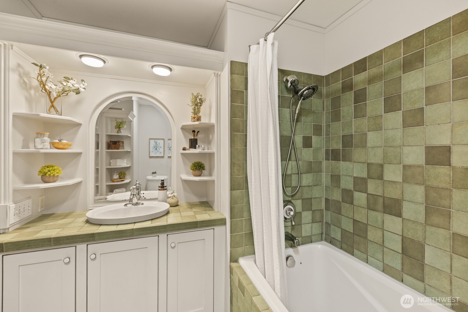 2350 10th Avenue East, Unit 227 Seattle, WA 98102 - Photo 20 of 34 a bathroom with a granite countertop sink a mirror a bathtub and shower