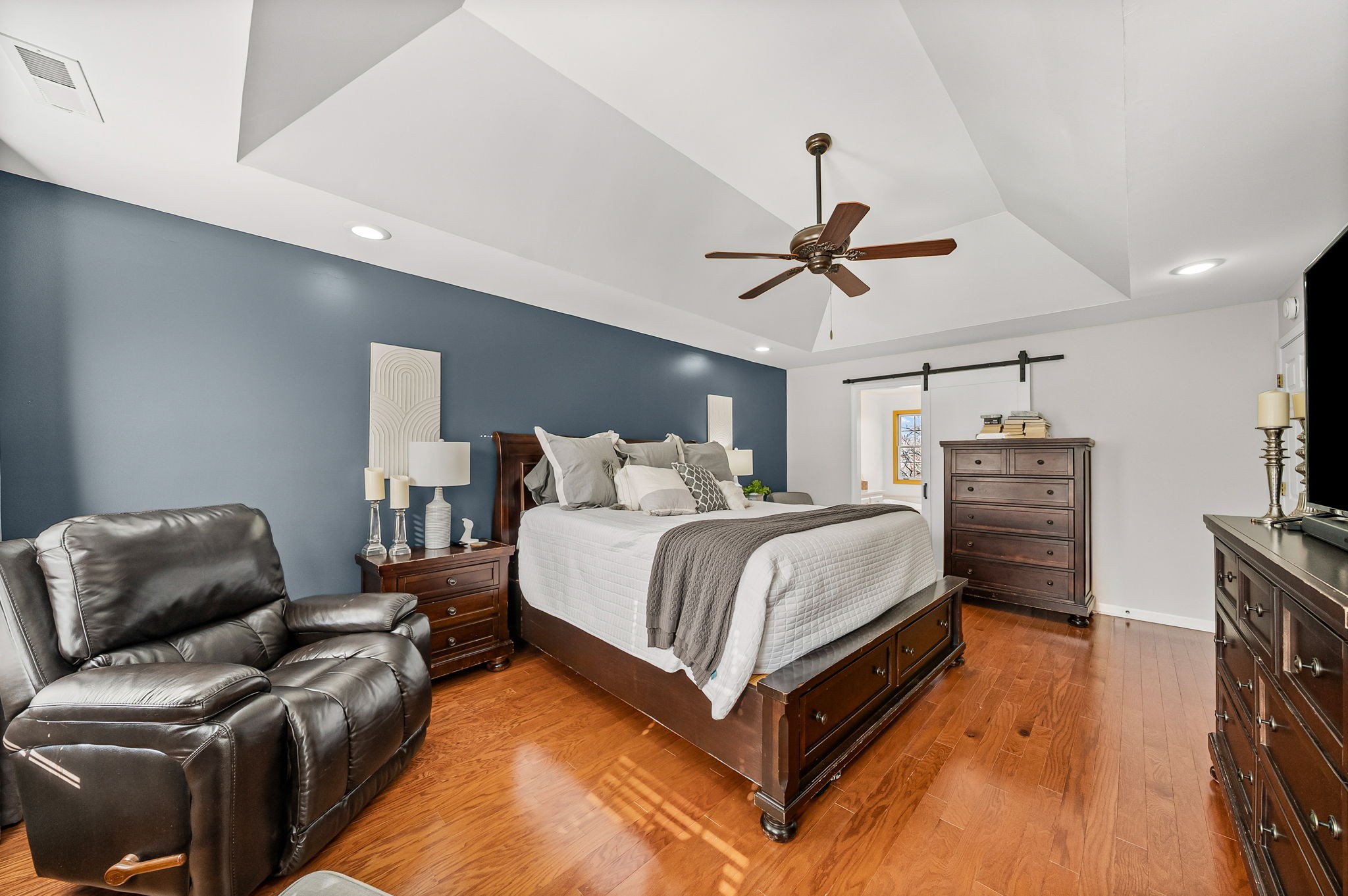 508 Sheffield Road Hopkinsville, KY 42240 - Photo 31 of 65 a spacious bedroom with a bed a couch and a chandelier