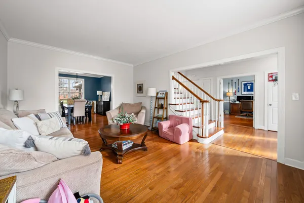 a kitchen with stainless steel appliances granite countertop a stove top oven a refrigerator a sink and chairs