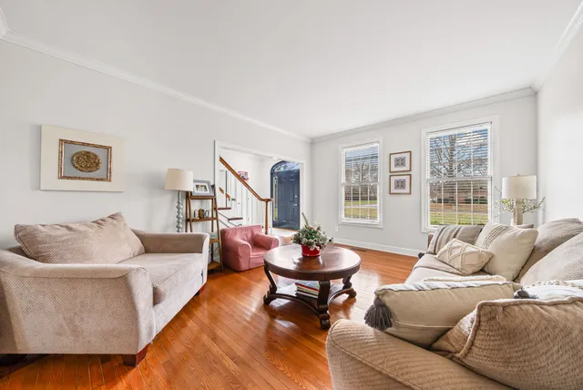a kitchen with stainless steel appliances a dining table chairs sink and cabinets
