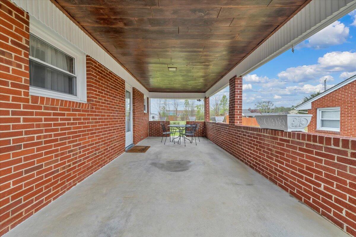 5156 Hazelridge Road Northwest Roanoke, VA 24012 - Photo 28 of 30 a view of a patio with table and chairs with wooden floor and fence