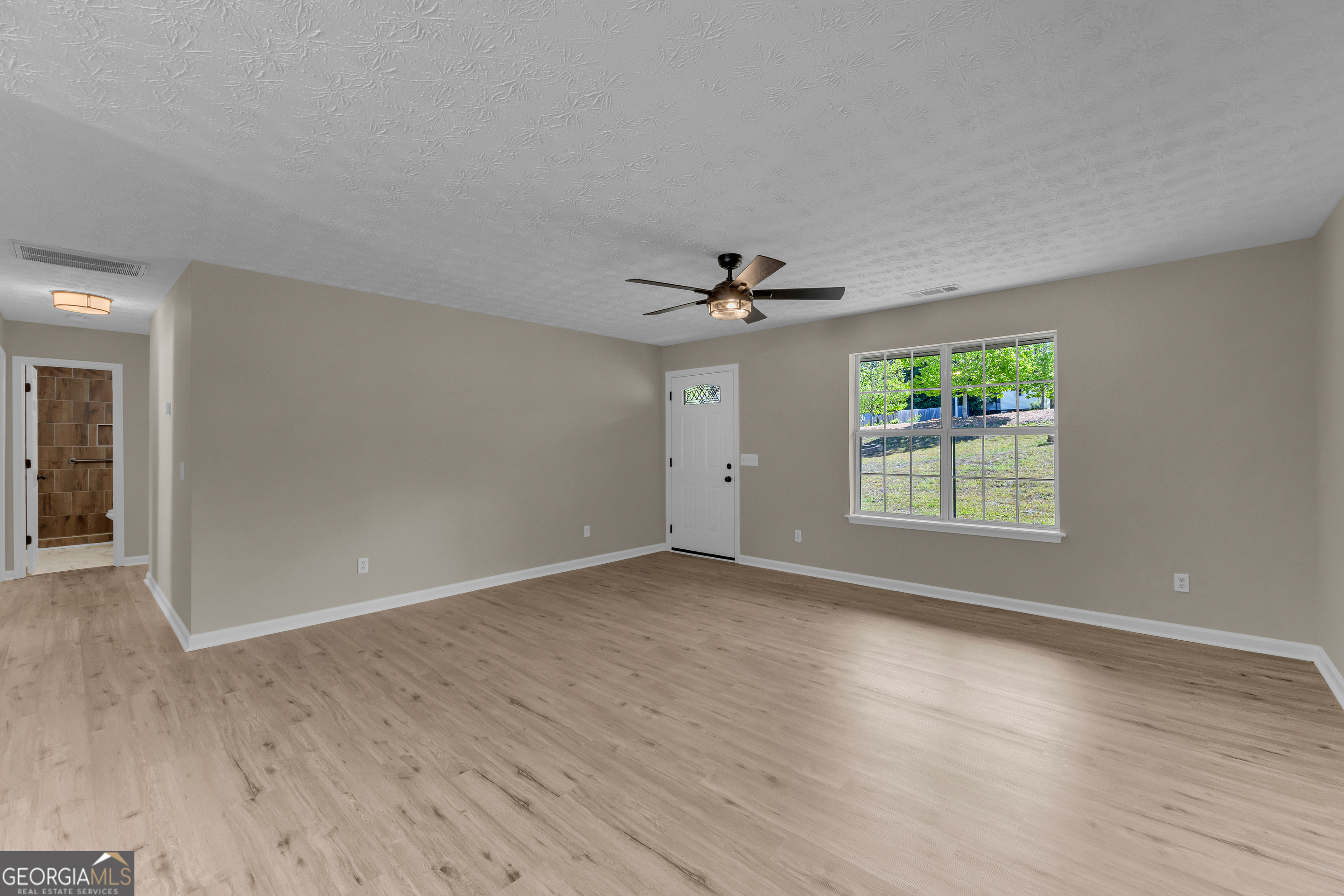 248 Highland Estates Commerce, GA 30529 - Photo 20 of 57 a view of an empty room with wooden floor and a window