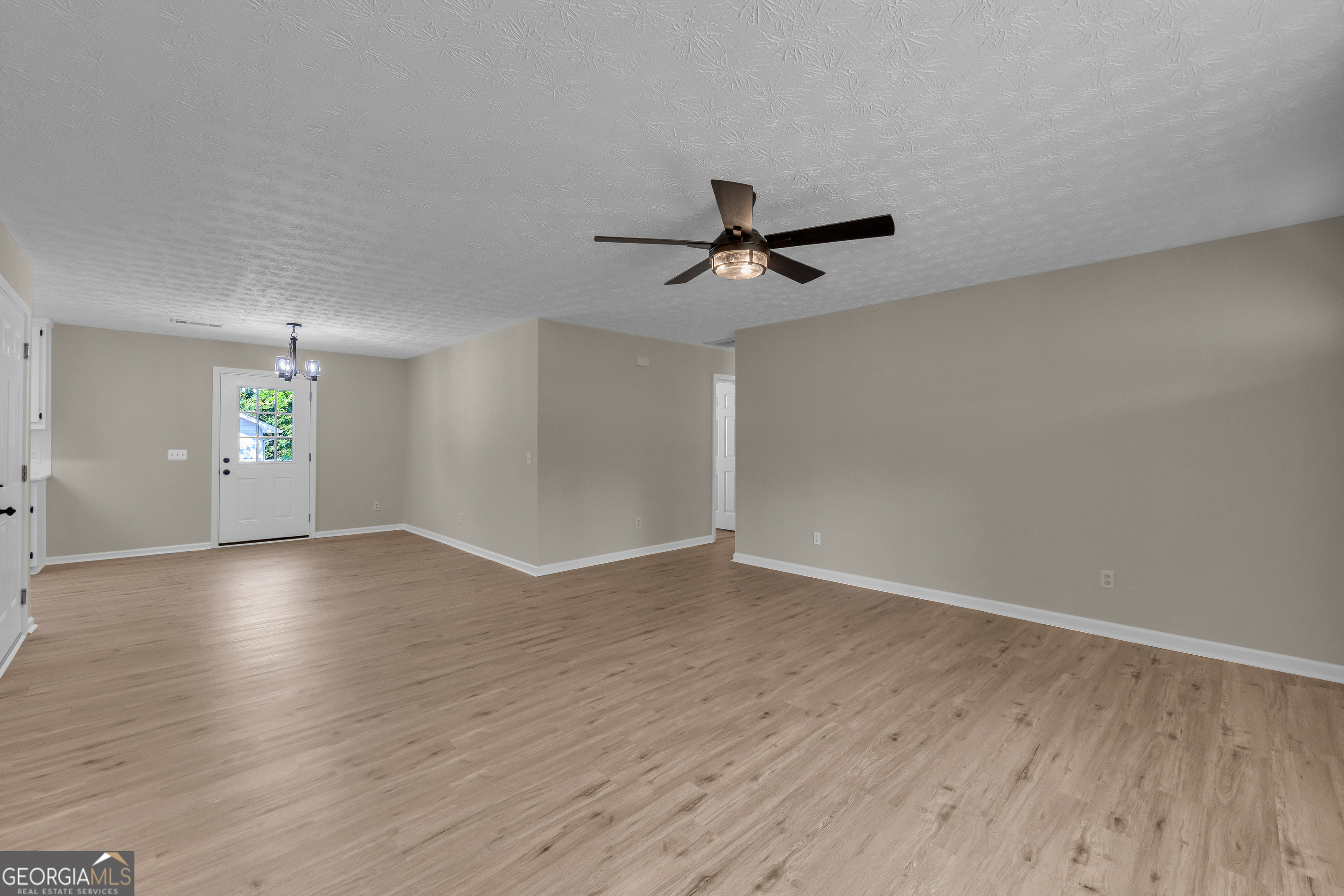 248 Highland Estates Commerce, GA 30529 - Photo 21 of 57 an empty room with wooden floor and windows