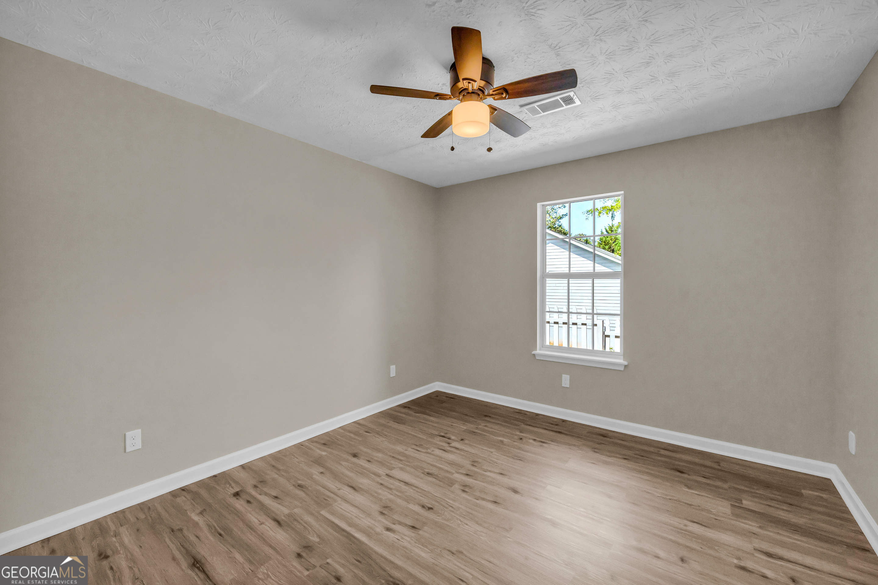 248 Highland Estates Commerce, GA 30529 - Photo 32 of 57 an empty room with wooden floor and windows