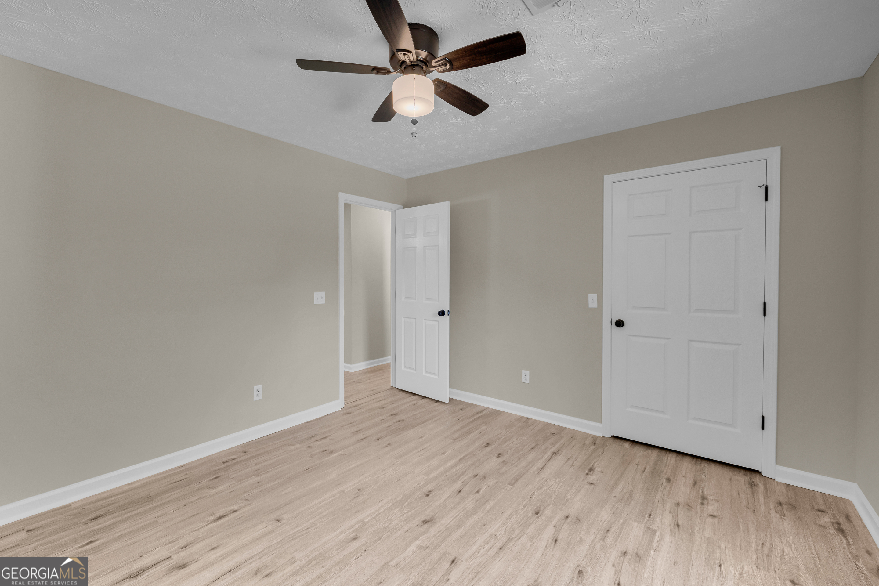 248 Highland Estates Commerce, GA 30529 - Photo 35 of 57 an empty room with wooden floor fan and windows