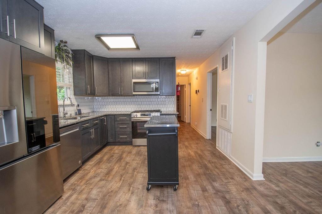 6200 Fieldcrest Drive Morrow, GA 30260 - Photo 7 of 19 a kitchen with stainless steel appliances granite countertop a refrigerator a stove top oven and a sink