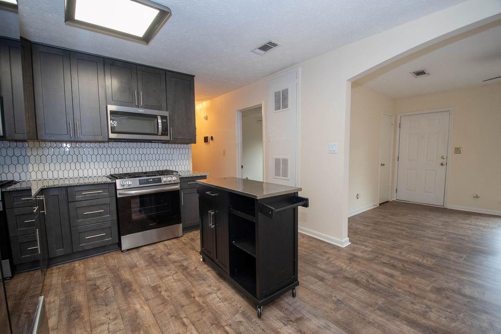 6200 Fieldcrest Drive Morrow, GA 30260 - Photo 8 of 19 a kitchen with stainless steel appliances granite countertop a stove and a refrigerator