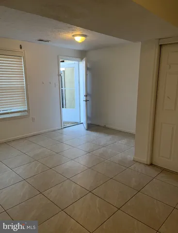 a view of an empty room and a window