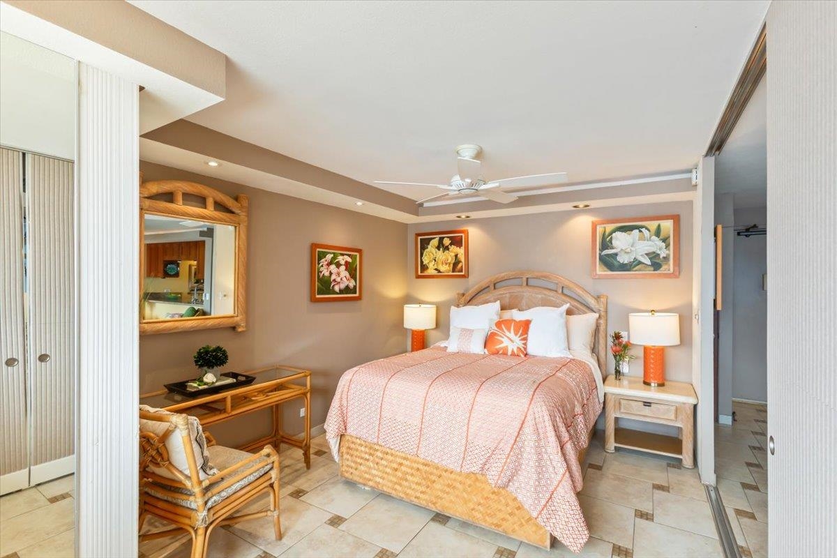 191 North Kihei Road, Unit 402 Kihei, HI 96753 - Photo 11 of 48 a bedroom with a bed and wooden floor