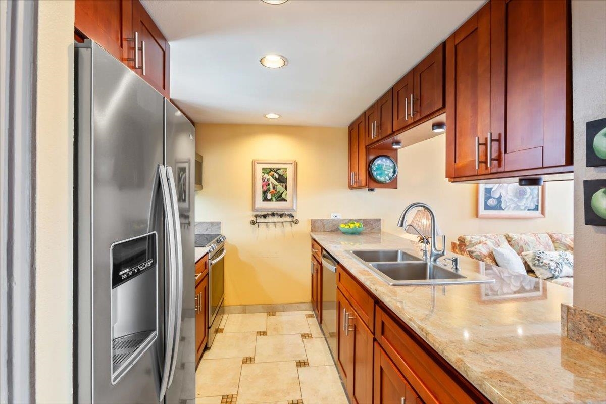 191 North Kihei Road, Unit 402 Kihei, HI 96753 - Photo 13 of 48 a kitchen with stainless steel appliances granite countertop a sink and a refrigerator