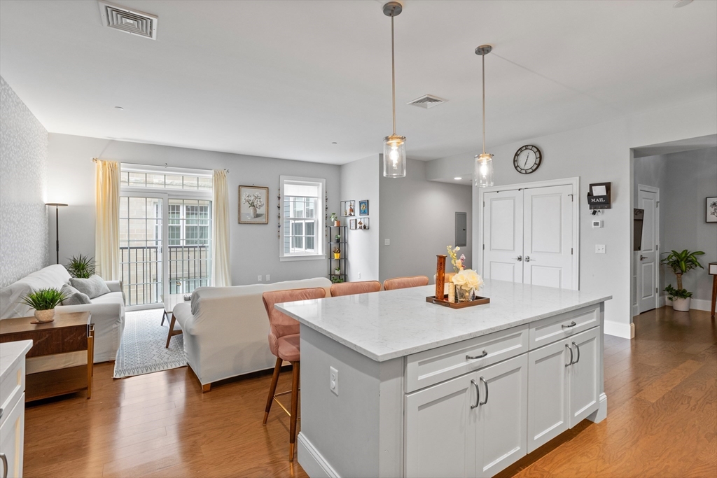8 Sanborn Street, Unit 2012 Reading, MA 01867 - Photo 12 of 36 a view of living room with granite countertop furniture and wooden floor