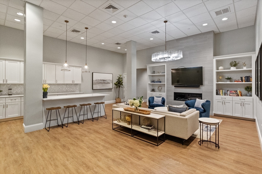 8 Sanborn Street, Unit 2012 Reading, MA 01867 - Photo 29 of 36 a living room with furniture and a flat screen tv