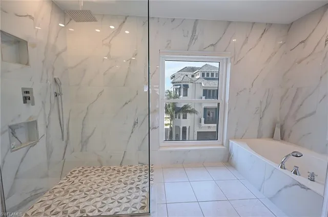 a bathroom with a bathtub and a shower