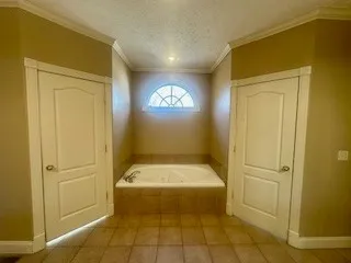 a bathroom with a tub and shower