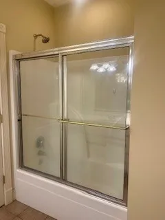 a bathroom with a glass shower door