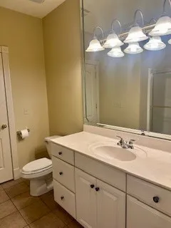 a bathroom with a sink mirror and toilet