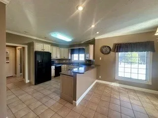 a kitchen with stainless steel appliances granite countertop a refrigerator and a stove top oven