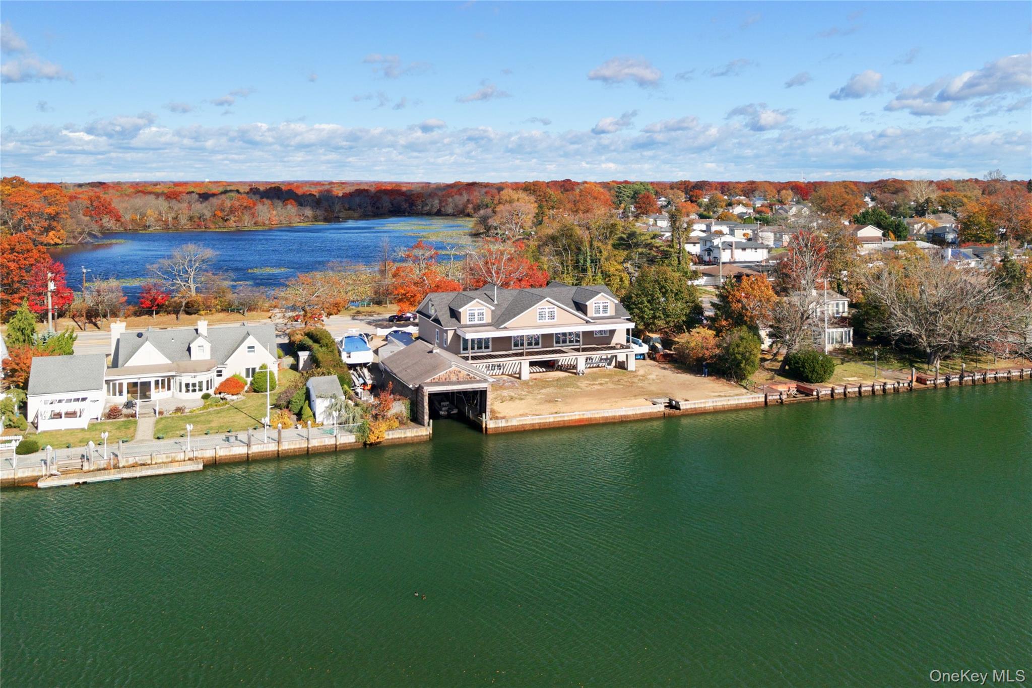 4530 Merrick Road Massapequa, NY 11758 - Photo 13 of 33 a view of a lake with lawn chairs