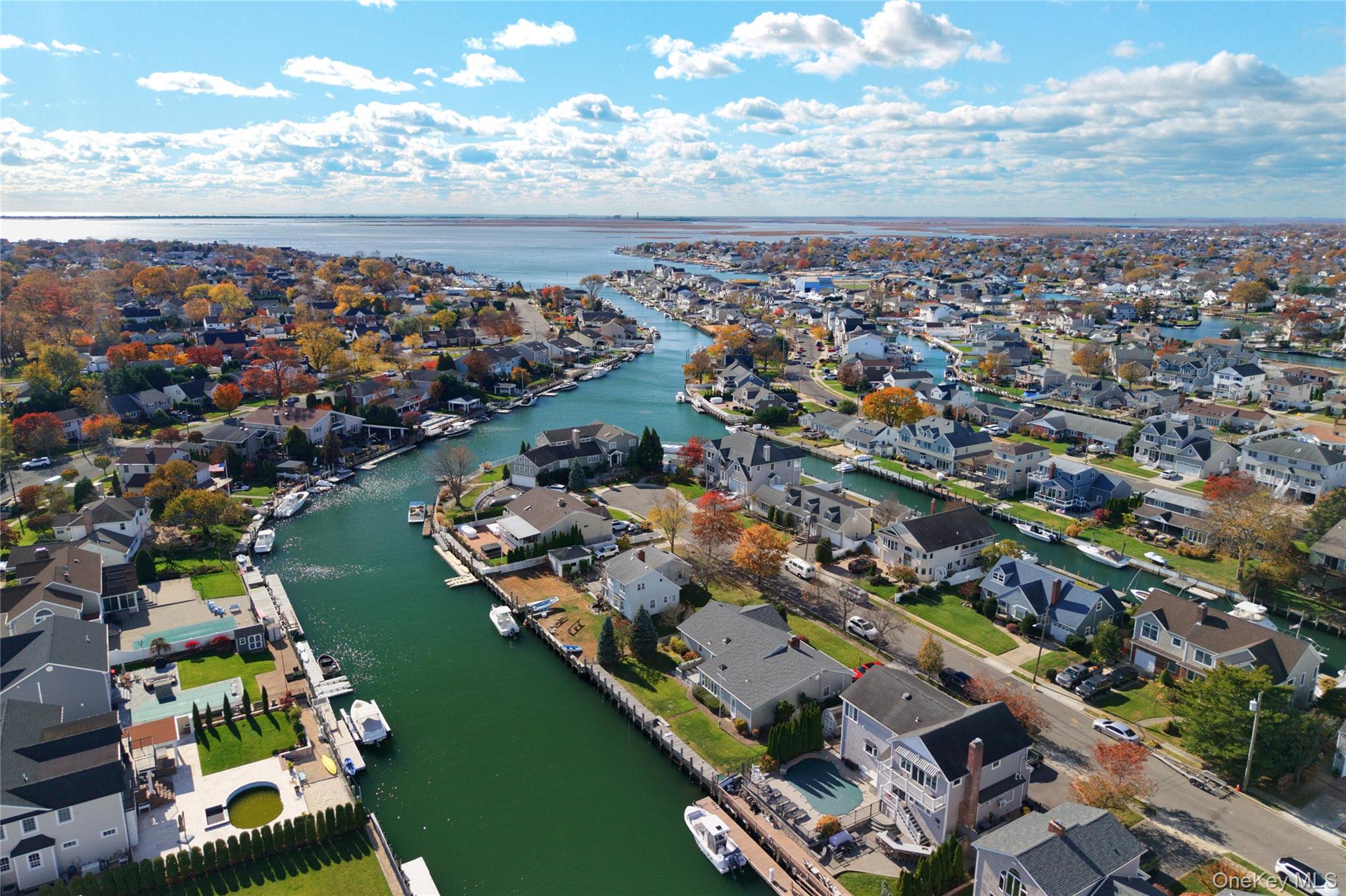4530 Merrick Road Massapequa, NY 11758 - Photo 21 of 33 an aerial view of a city with lots of residential buildings ocean and mountain view in back