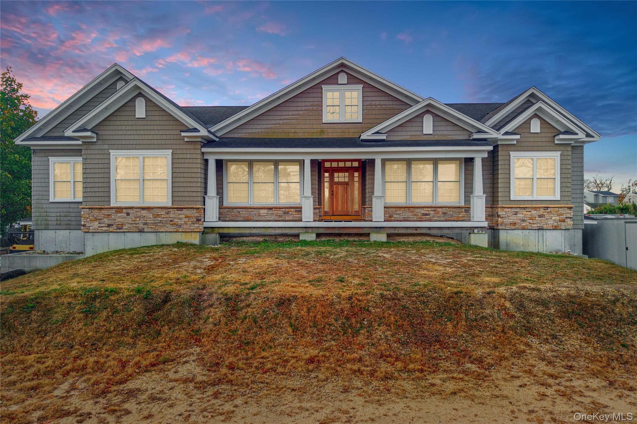 4530 Merrick Road Massapequa, NY 11758 - Photo 5 of 33 a front view of a house with garden