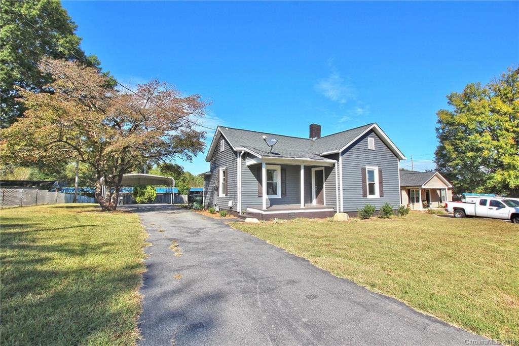 694 Main Street Southwest Concord, NC 28027 - Photo 2 of 33 a front view of a house with a garden and trees