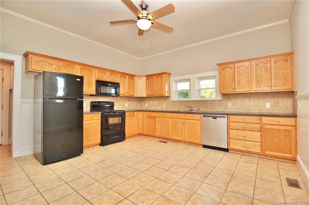 694 Main Street Southwest Concord, NC 28027 - Photo 11 of 33 a kitchen with granite countertop a refrigerator and a sink