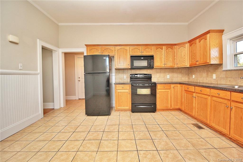 694 Main Street Southwest Concord, NC 28027 - Photo 12 of 33 a kitchen with stainless steel appliances granite countertop a refrigerator sink and cabinets